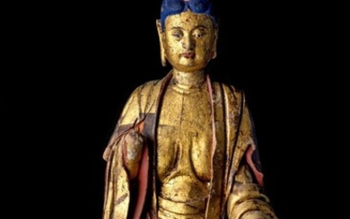 A Chinese gilt and painted stucco figure of Buddha, Ming dynasty with later pigment, the rounded squarish face with downcast eyes and thick lips, hair covered in blue pigment atop a jewel, forehead adorned with a red urna, seated in ardha padmasana...