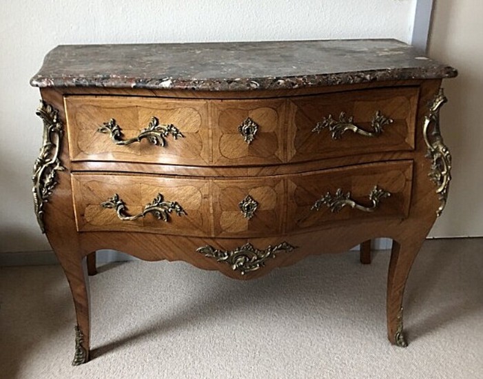 A French walnut rococo style chest of drawers, c. 1930. With top of marble. H. 85. W. 114. D. 62 cm.