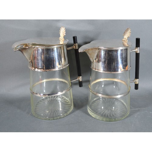 A Pair of Silver Plated and Cut Glass Claret Jugs in the sty...