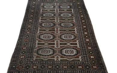 A Persian silk cream and brown ground carpet with geometric...