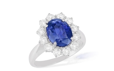 A SAPPHIRE AND DIAMOND CLUSTER RING The oval-shaped sapphir...
