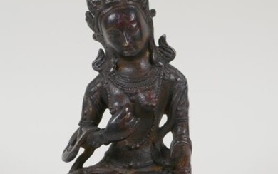 A Sino Tibetan bronze figure of a goddess seated...