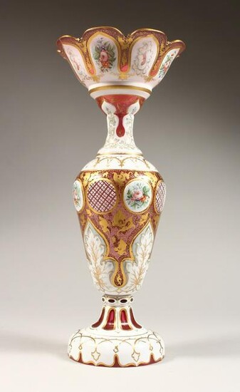 A TALL BOHEMIAN WHITE OVERLAY RED VASE with decoration