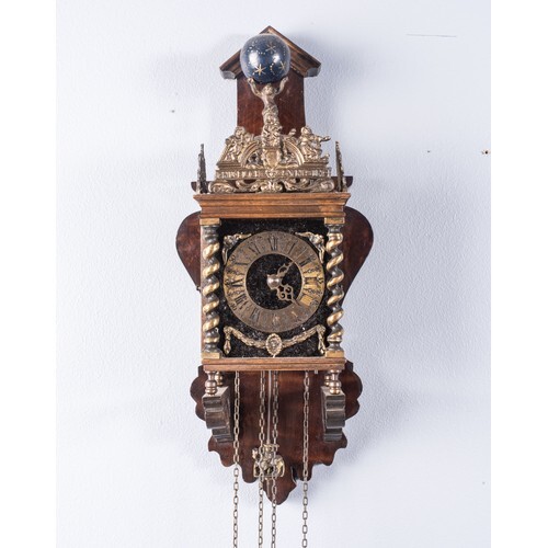 A WOOD AND BRASS WALL CLOCK