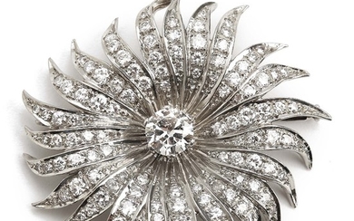 A diamond brooch in the shape of a flower set with an old-cut diamond weighing app. 0.95 ct. encircled by brilliant-cut diamonds, mounted in platinum. 1950.