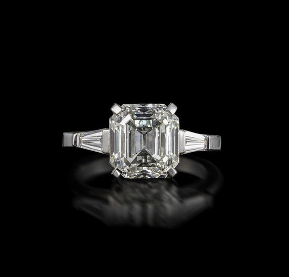 A diamond solitaire ring, the Asscher-cut diamond weighs...