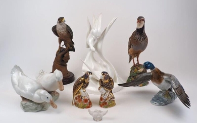 A group of bird sculptures, 20th century, to include a pair of Royal Crown Derby Imari style paperweights as parrots atop a rocky outcrop, with gold stoppers, each 15.7cm high, together with, a Royal Doulton Images white porcelain figure...