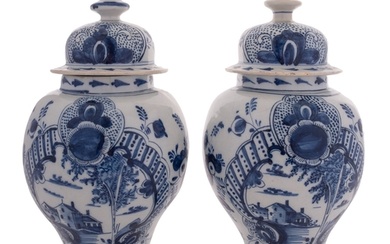 A pair of Dutch Delft blue and white baluster vases and cove...