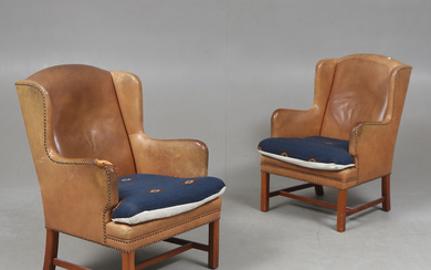 A pair of English style 20th century armchairs.