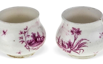 A pair of Hochst pot à jus or Creme Topfchen, c.1755, red wheel marks, painted in purpurmalerei with landscape vignettes on rococo scroll supports, with scrolling branch handles, 5cm high (2) Provenance: Works of Art from the Schroder Collection...