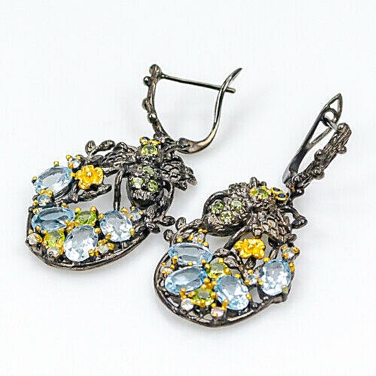 A pair of ear pendants each set with numerous oval and circular-cut topazes, peridots and citrines, mounted in black rhodium and gold plated silver.