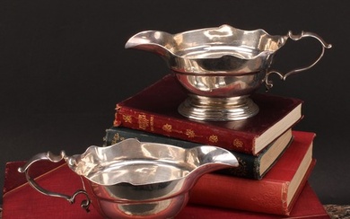 A pair of early George II silver sauce boats, wavy borders, ...