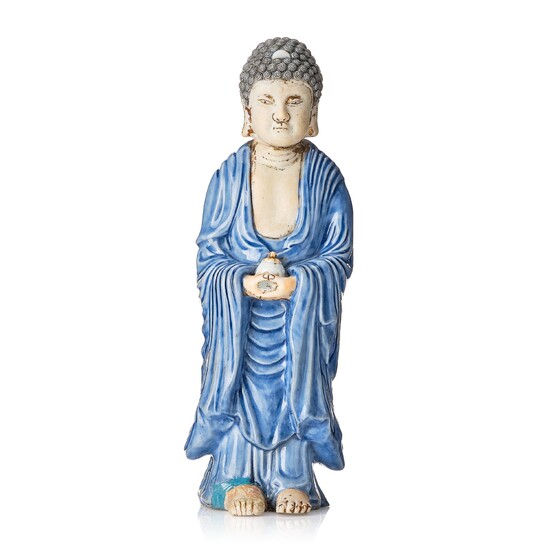 A porcelain figure of a standing Buddha, Qing dynasty, 18th Century.