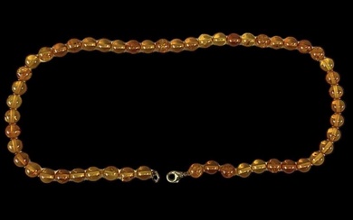 A single strand of amber coloured beads with a 9ct...