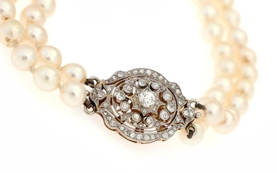 SOLD. A two strand pearl necklace set with numerous cultured freshwater pearls, diamond clasp set...