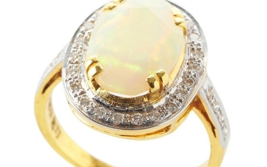 AN OPAL AND DIAMOND CLUSTER RING IN 18CT GOLD, FEATURING AN OVAL SOLID OPAL OF 2.85CTS, IN A SURROUND OF DIAMONDS, SIZE O, 5.5GMS