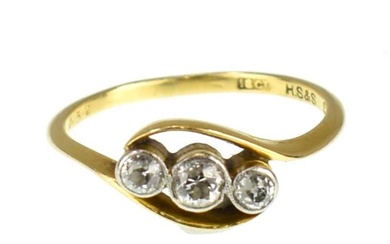 An 18ct gold three-stone diamond ring, the three small bezel...