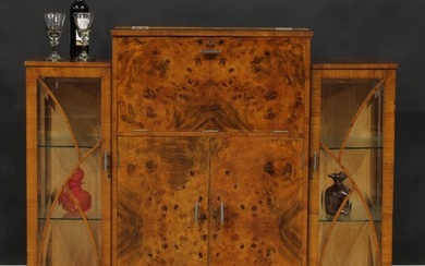 An Art Deco burr walnut cocktail cabinet, hinged top and fal...