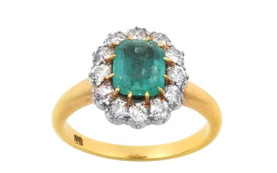An Emerald and Diamond Cluster Ring the emerald-cut emerald in...