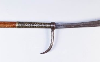 An Indo-Persian Polearm, the wood shaft with brass terminal...