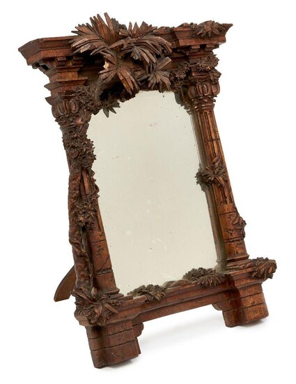 An Italian carved walnut table mirror, mid 19th century, of...
