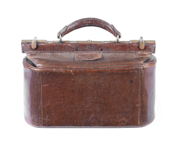 An early 20th century leather and brass cased bowls bag and contents
