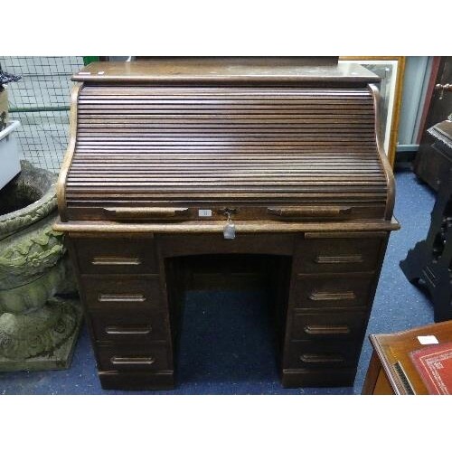 An early 20thC oak Roll Top Desk, by Warings (Waring & Gillo...