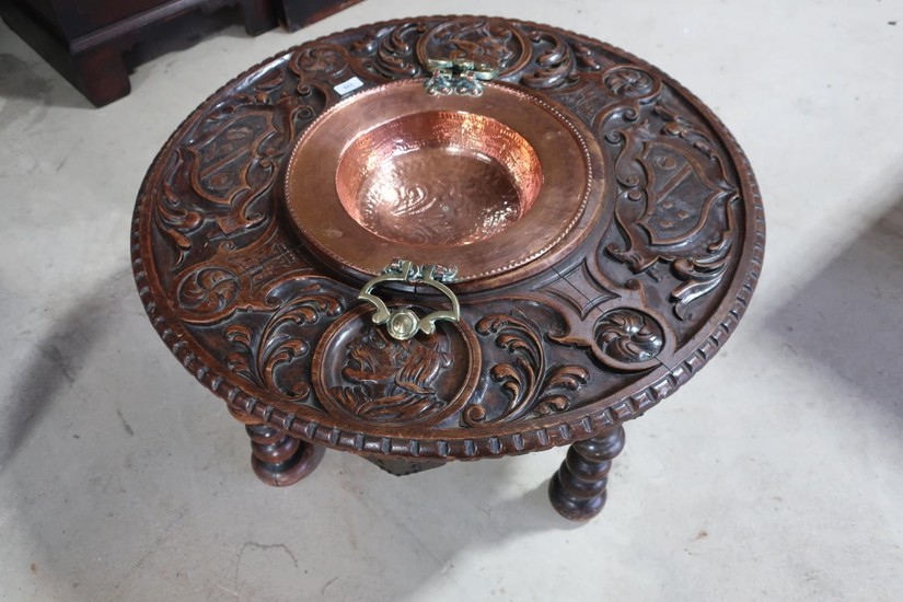 Carved walnut circular occasional table with Baronial type d...