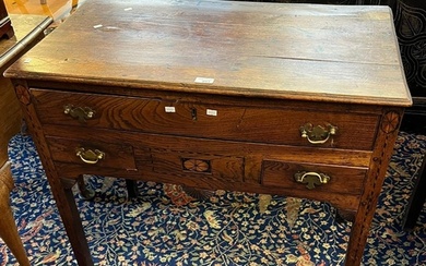 Early 19th century oak lowboy, the moulded top above an arra...