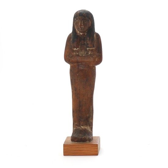 Egyptian wood ushabti with remains of paint. 18th-19th dynasty. H. 21,5 cm.