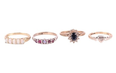 Four gem set rings, comprising a sapphire and CZ cluster ring with hallmarks for 9ct gold, ring size