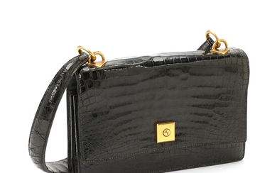 NOT SOLD. Hermès: A bag made of black crocodile skin with gold toned hardware, a...