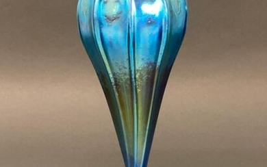Louis Comfort Tiffany (American,early 20th Century) A slender blue glass vase with iridescent overlay, signed and numbered. Circa 1900. Height 23.3 cm.