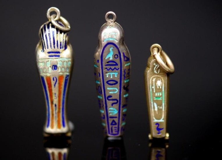 Three 1920's silver sarcophagus form pendants with enamel decoration....