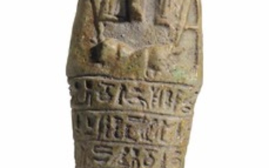 AN EGYPTIAN GREEN FAIENCE SHABTI FOR THE OVERSEER OF THE WRITINGS OF THE ROYAL MEAL, PSAMTEK, BORN OF MER-NEITH, LATE PERIOD, 27TH DYNASTY, CIRCA 525-500 B.C.