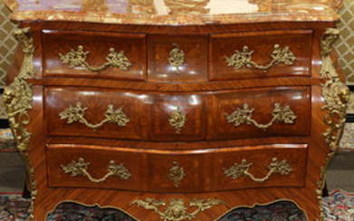 Louis XV style ormolu mounted commode, having a serpentine marble top above the four drawer case of bombe form, with ornate pulls wi...