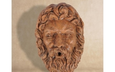 A substantial sculpted marmo Verona wall fount modelled as a bearded Bacchic mask in Baroque taste