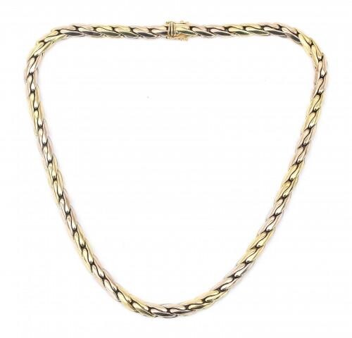 A 14 karat gold two tone necklace. A curb necklace in white and yellow gold to a tongue clasp with two safety eyes. Gross weight: 38.3 g.