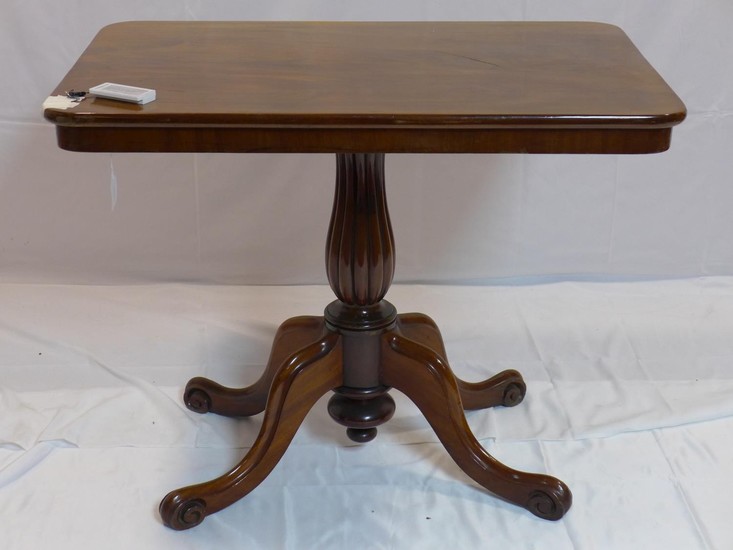 A 19th century mahogany tilt top table, raised on reeded bal...
