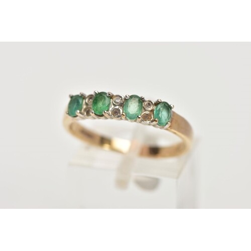 A 9CT GOLD EMERALD AND DIAMOND HALF ETERNITY RING, designed ...