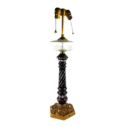 A BOHEMIAN RUBY GLASS AND BRASS OIL LAMP Twin electric lamps...