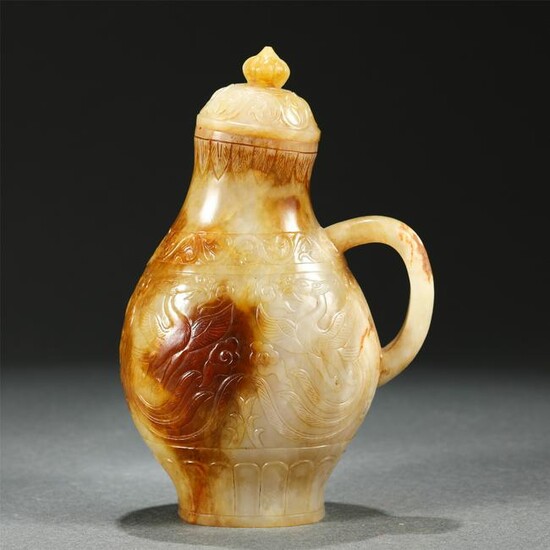 A CARVED WHITE AND RUSSET JADE VASE WITH ONE HANDLE
