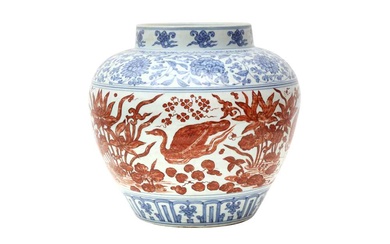 A CHINESE COPPER RED-ENAMELLED BLUE AND WHITE 'LOTUS POND' JAR 或為明 青花紅料蓮池罐