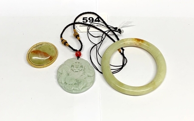 A Chinese carved jade amulet, Dia. 4.5cm, together with a jade bangle and a jade inset brooch.