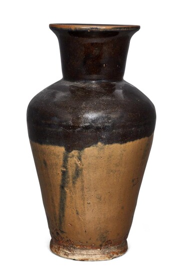 A Chinese stoneware brown-glazed vase, Ming dynasty, the top half covered in a thick dark brown glaze stopping mid way to a light brown tone, unglazed base, 32.5cm high 明 醬釉敞口瓶