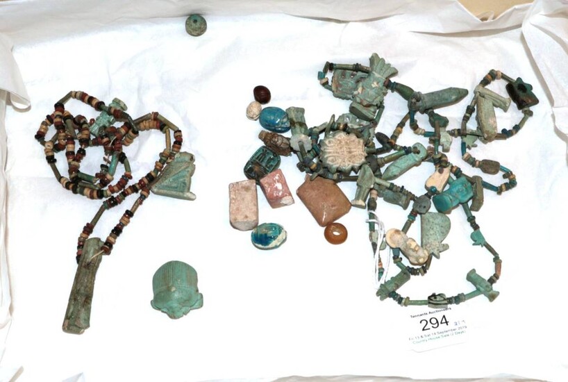 A Collection of Pharonic Egyptian Faience Amulets and Beads, strung as two necklaces. Reputedly...