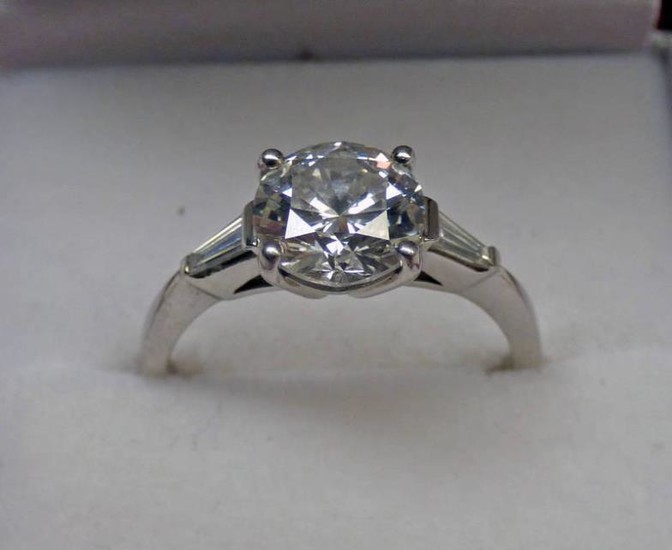 A DIAMOND SOLITAIRE RING, THE BRILLIANT-CUT DIAMOND OF APPROX....