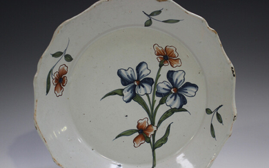 A Delft plate, 18th century, painted in blue, green and red with a floral spray, diameter 22.5cm (sm