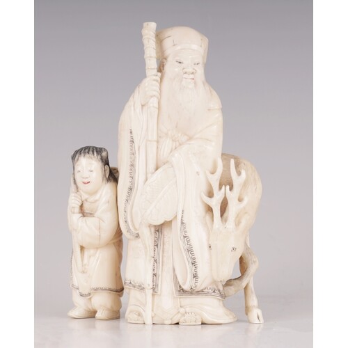† A FINELY CARVED CHINESE IVORY SCULPTURE depicting a sage w...