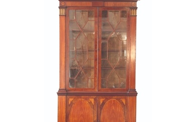 A GEORGE III MAHOGANY AND SATINWOOD LIBRARY BOOKCASE in the...
